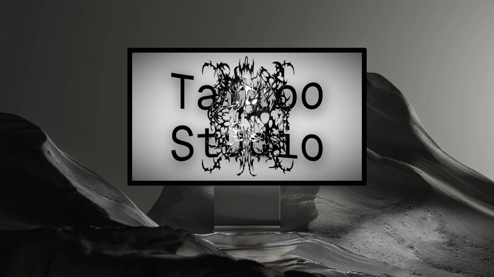 Monochrome scene with a laptop with Tattoo Studio's custom branding on it